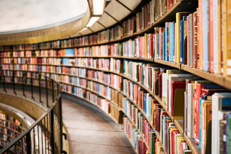 A curved wall of bookshelves in a reading room.